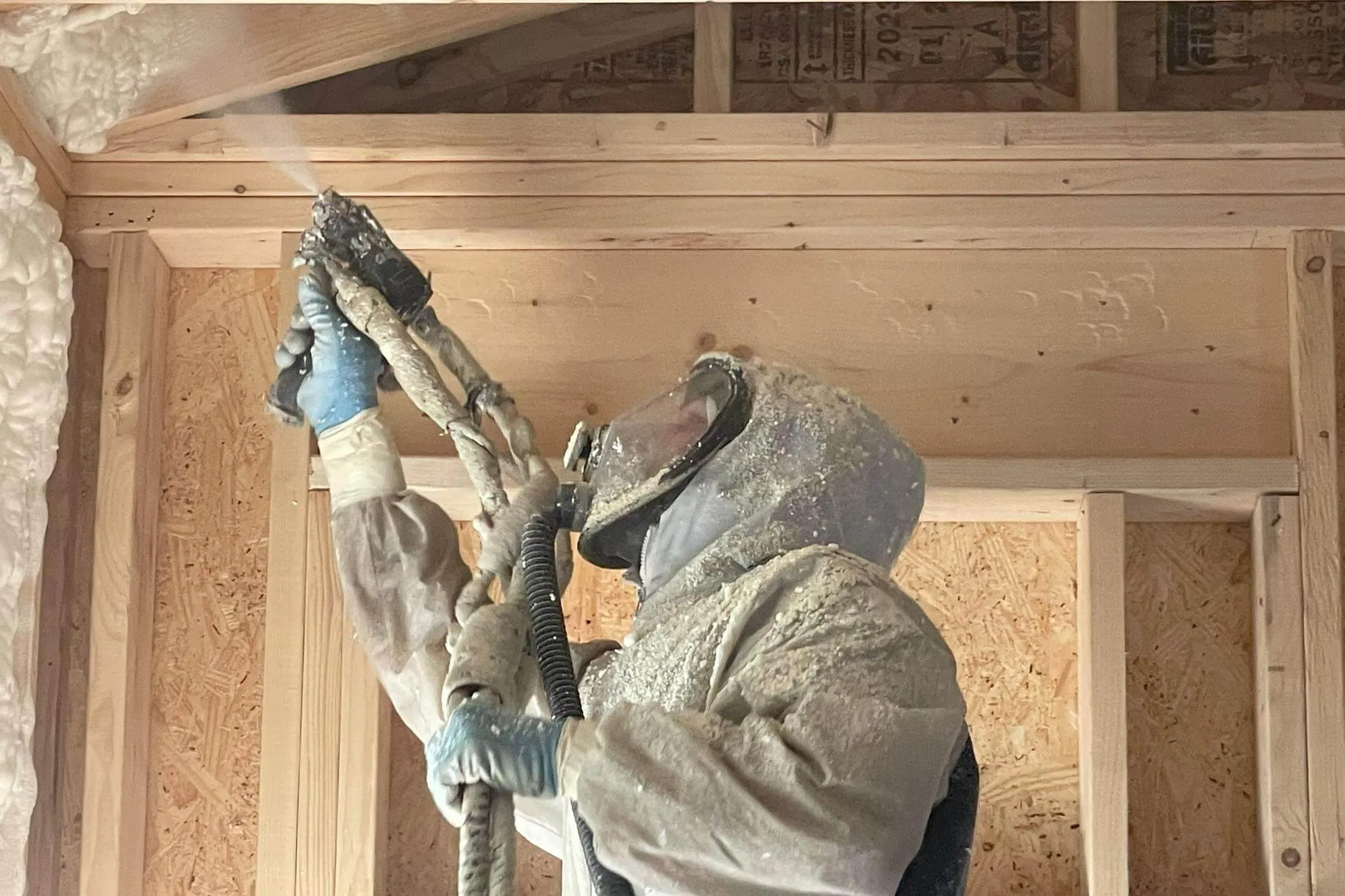 Professional installer applying spray foam insulation in an Arizona building